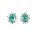 A PAIR OF EMERALD AND DIAMOND EAR STUDS