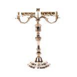 A POLISH BRASS OIL-BURNING HANUKAH LAMP, CIRCA 1850 on a shaped circular floriform base with a