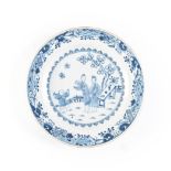 A CHINESE BLUE AND WHITE PLATE the central rondel depicting figures at various pursuits before a