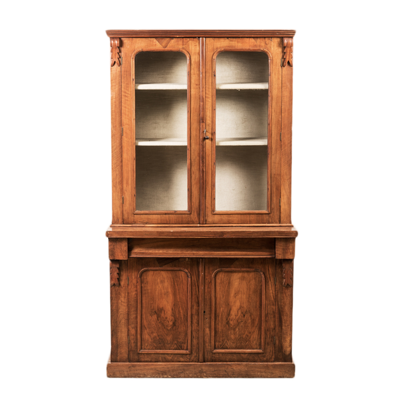 A VICTORIAN MAHOGANY BOOKCASE in two parts, the outswept moulded cornice above a pair of glazed