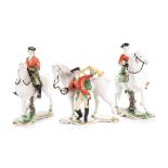 A GROUP OF THREE NYMPHENBURG GLAZED HUNTING FIGURES naturalistically modelled, comprising: a lady on