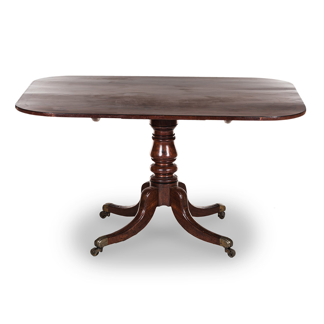 A MAHOGANY BREAKFAST TABLE, 19TH CENTURY the shaped hinged rectangular top on a ring-turned tapering