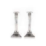 A PAIR OF GEORGE V SILVER CORINTHIAN COLUMN CANDLESTICKS, FLORENCE WARDEN, TOWN MARK FOR CHESTER,