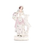 A STAFFORDSHIRE FIGURE OF A WOMAN, 19TH CENTURY modelled standing, holding a vase, with a goat to