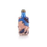 A CHINESE BROWN OVERLAY PEKING GLASS SNUFF BOTTLE depicting dog of fo, bats, flaming pearl and a