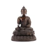 A BRONZE BUDDHA seated in dhyansana on a double lotus throne with hands in bhumisparsha mudra,