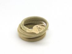 Vintage coiled snake bangle, gold mesh expanding body with ruby set eyes, stamped and tested as 9ct