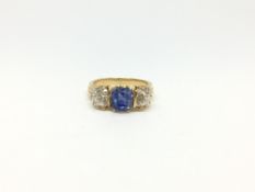 Sapphire and diamond ring, central cushion cut cornflower blue sapphire weighing an estimated 2.