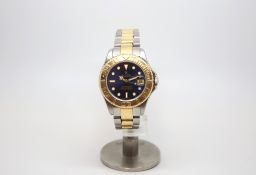 Rolex midsize Yacht-Master, circular blue dial luminous hour marks, gold rotating bezel, steel and