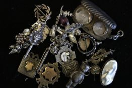 A quantity of mostly antique and unusual silver items including a silver bear and fobs, weighing
