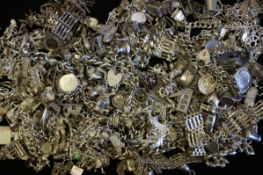A quantity of mostly vintage silver charm bracelets and charms, weighing approximately 1736g gross