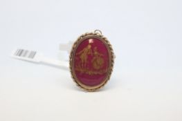 Enamel porcelain oval brooch, red enamel background with gold on top depicting a lady, with a