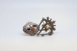 Two silver brooches, one in the form of two intersecting hearts under a crown, and set with a