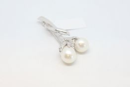 Pearl and diamond floral brooch, two white cultured pearls measuring approximately 9mm, in the