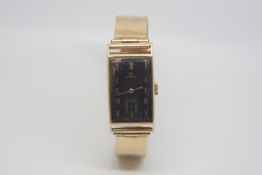 Vintage Omega gold bracelet watch, rectangular black dial with gilt Roman numerals, subsidiary