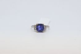 An Art Deco Sapphire and Diamond Ring. The white metal mount stamped Plat. Central sapphire is