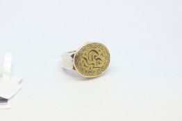 Silver emblem ring, with a yellow metal carved top, ring size P
