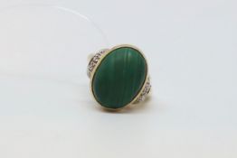 Single stone malachite ring, oval cut malachite with diamond detail to the shoulders, mounted in 9ct