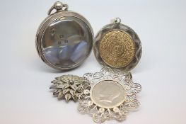 A selection of silver items including a pocket watch case, a filigree brooch and two pendants.