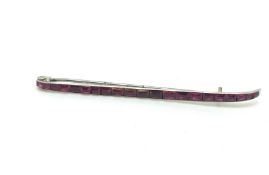 Ruby bar brooch, set with calibre cut rubies, in white metal, signed 'Cartier Paris London New