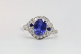 Art Deco style sapphire and diamond ring, oval cut sapphire measuring 9 x 6.5mm, in a round