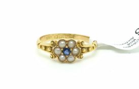 Sapphire and pearl cluster ring, central faceted sapphire surrounded by six split pearls, with