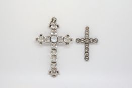 Two paste crosses in white metal tested as silver. Smaller is closed back and is 3.8cm in length