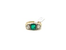 Emerald and diamond three stone ring, central 7x5.8mm emerald, set with a single old cut diamond