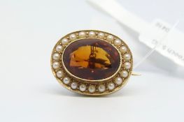 Victorian style brooch, central oval cut citrine surrounded by split pearls, stamped 15ct,