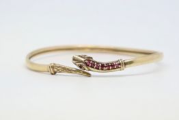 9ct yellow gold snake bangle, flexible bangle with engraved detail to the tail, the head set with
