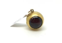 Sphere pendant/charm, one side set with a cabochon garnet, the other side set with a locket with