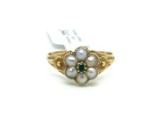 Emerald and pearl cluster ring, central faceted emerald surrounded by six pearls, with carved