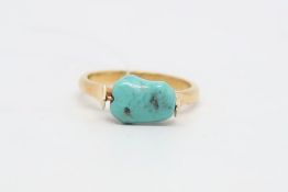 Turquoise set ring centrally set with a piece of turquoise stone, mounted in yellow metal stamped