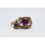Victorian pendant, with a central oval purple stone measuring 21 x 18mm, in a closed yellow metal