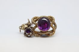Victorian pendant, with a central oval purple stone measuring 21 x 18mm, in a closed yellow metal