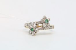 Emerald and paste cluster ring, two daisy clusters in a cross over design with paste set