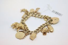 9ct yellow gold charm bracelet, 9 gold charms including an elephant, keys, and bells, gross weight