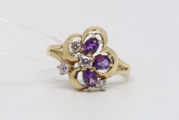 Cubic zirconia flower cluster ring, white and purple stones set in a cluster design, mounted in