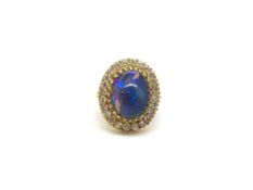 Black opal and diamond ring, large oval cabochon cut black opal approximately 17x12x8mm, claw set