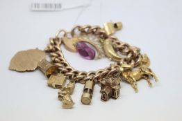 9ct charm bracelet, including antique fob, horse and horn charms, weight approximately 70 grams