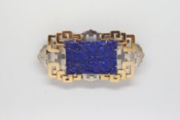 A white and yellow gold brooch set with a carved lapis panel, in a fitted Hamilton and Co box.