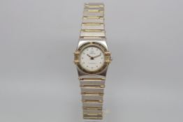 Ladies Omega constellation, white dial with dot hour markers, gold bezel with Roman numerals,
