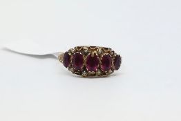 An antique garnet and pearl ring. Ring size Q 1/2. Hallmarked for 9ct gold.