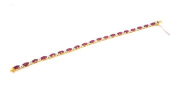 Ruby and diamond tennis bracelet, oval cut rubies claw set, spaced with clusters of four brilliant