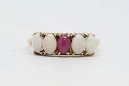 Five stone gem set ring, central oval cabochon cut ruby with two cabochon cut opals to each side,