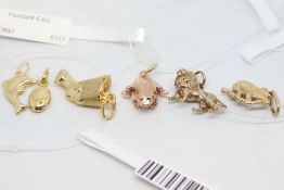 Six 9ct gold pendants, one in the form of a coffee bean and one in the form of a dolphin, a 9ct