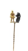 An unusual dancing bear stick pin, yellow gold figure with horn, with silver and gold standing bear,