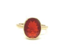 Single stone fire opal ring, oval cut fire opal, rubover set in 9ct yellow gold, ring size P