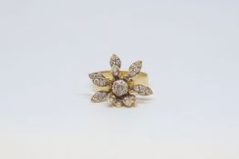 Floral dress ring, two rows of articulated and spinning petals set with white stones, mounted in