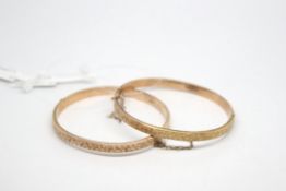 A matching pair of Edwardian rose gold clasp bangles, with engraved detail to the front of the